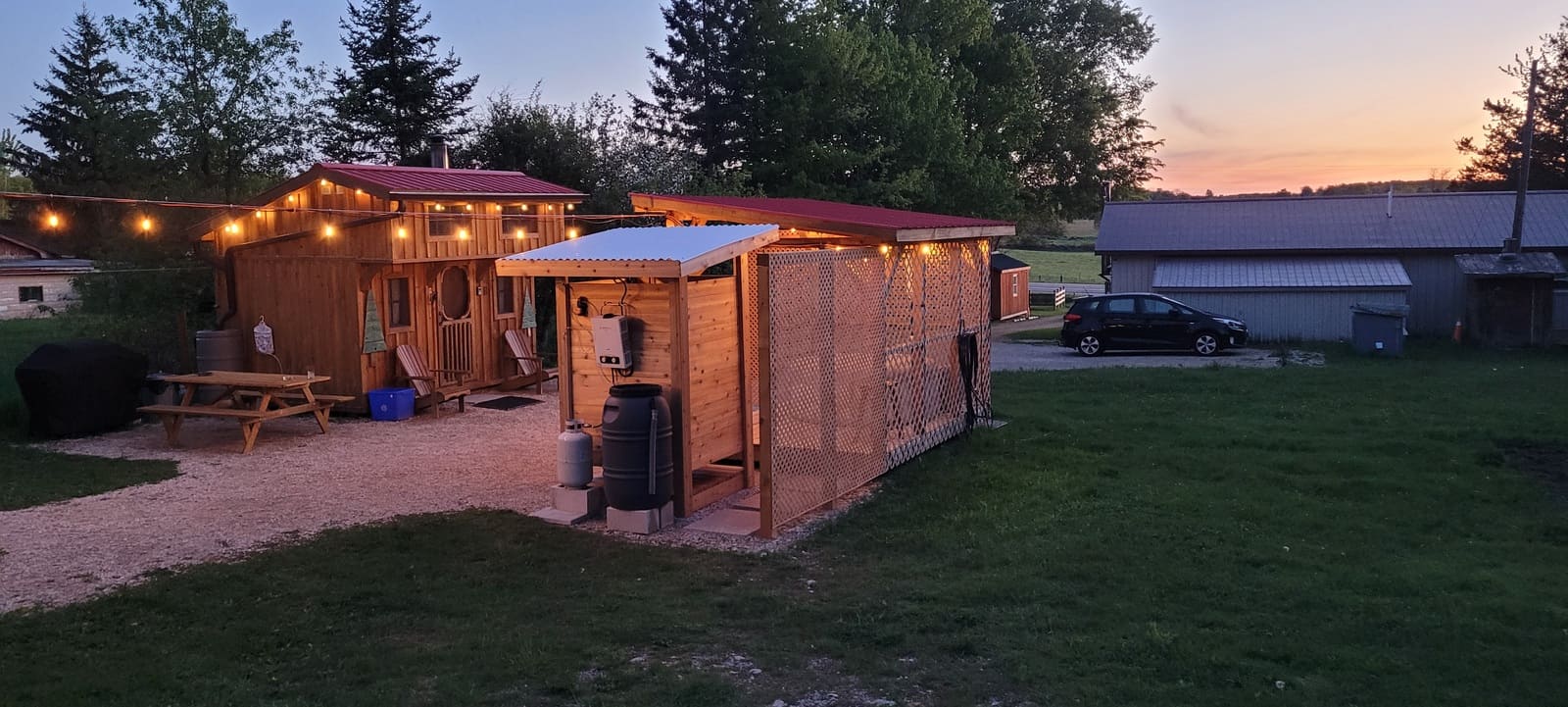 Outdoor kitchen at night with string lights